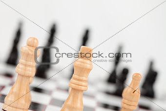 Chess pieces standing at the chessboard