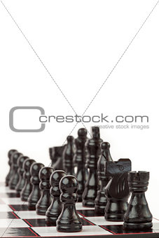 Black chess pieces standing at the chessboard
