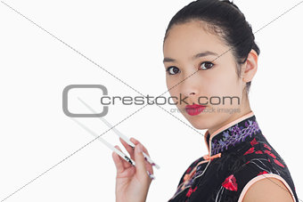 Woman in kimono holding chopsticks