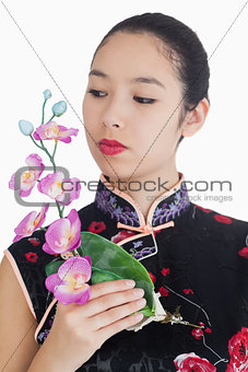 Woman in kimono holding orchid