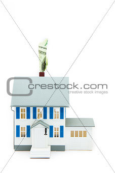 House with money coming out of the chimney