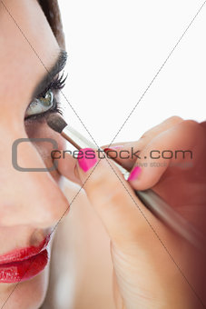 Woman making up smokey eyes