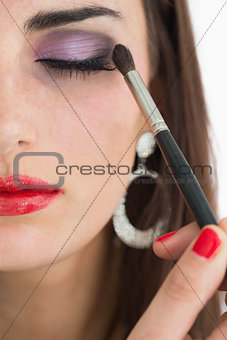 Woman applying smoky eyes