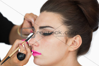 Woman getting applied cat eyes