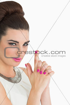 Woman forming a pistol with her hands