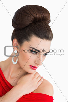 Woman looking down while wearing a red dress