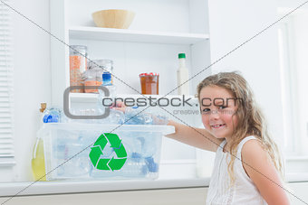 Girl sorting plastics into crates