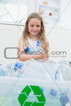 Girl sitting by boxes with plastic
