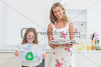 Mother and daughter holding waste