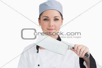 Smiling cook holding a meat cleaver