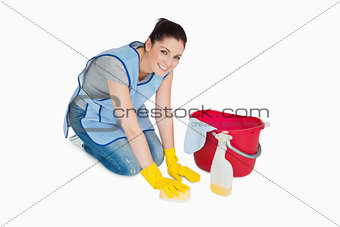Smiling cleaning woman washing the floor