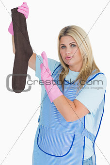 Cleaning woman holding a dirty sock