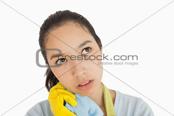 Tired woman clutching cleaning rag