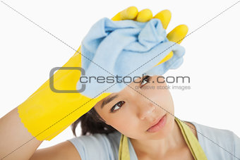 Overworked cleaning lady wiping her brow