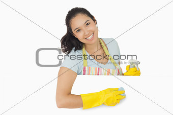 Happy woman wiping white surface