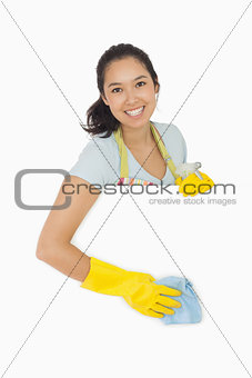 Smiling woman wiping down white surface