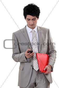 A businessman checking his cellphone.