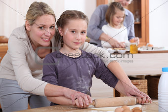mother and little girl cooking together