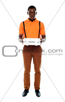 Full length portrait of delivery boy with pizza