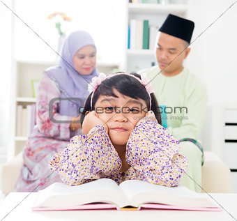 Malay girl reading book.