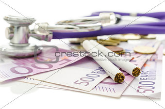 Cigarettes and stethoscope on Euro money