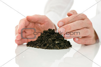 Male hands giving energy to soil