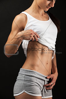 Young fitness woman over black