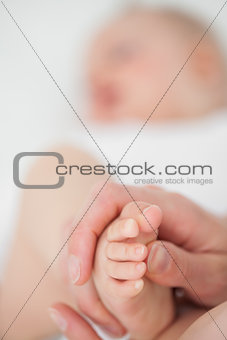 Feet of a baby being touched