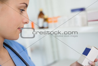 Nurse looking at a medicine box