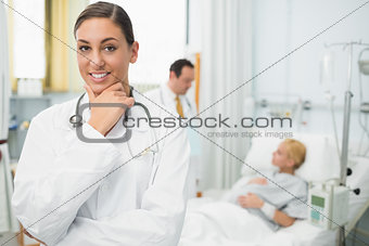 Female doctor folding her arms and holding her chin