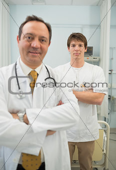 Doctor and a male nurse crossing their arms