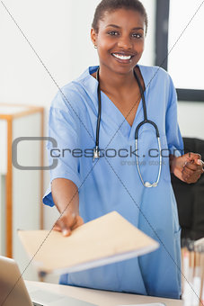 Nurse giving a folder at the reception