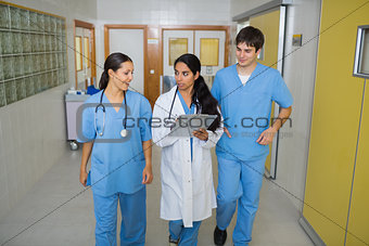 Nurses and a doctor walking in a hallway