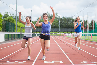 Athletes celebrating as they cross finish line
