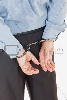 Rear view of businessman in handcuffs