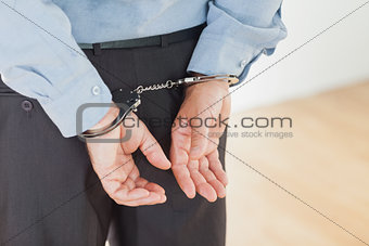 Hands of businessman with handcuffs