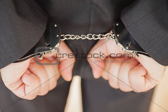 Attrested businessman clenching fists