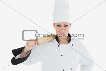 Female chef holding rolling pin