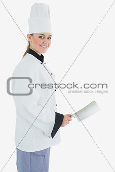 Portrait of female chef with meat cleaver