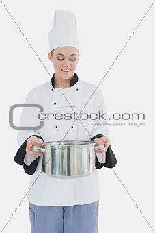 Happy chef holding utensil