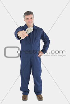 Mechanic with hand on waist holding vise grip