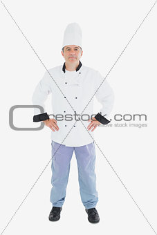 Confident chef standing with arms akimbo