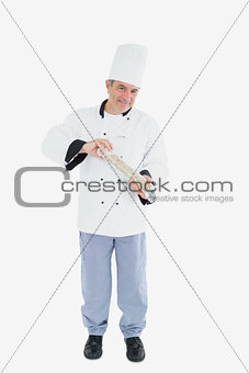 Happy chef using pepper mill