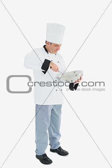 Male chef mixing ingredients using whisk