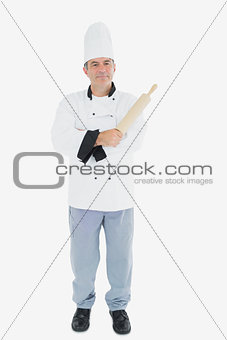 Portrait of male chef holding rolling pin