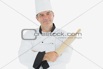Mature chef holding rolling pin