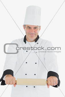 Male chef using rolling pin