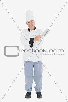 Confident chef with meat cleaver