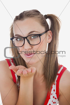 Portrait of young woman blowing air kiss