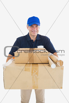 Happy courier man carrying cardboard packages